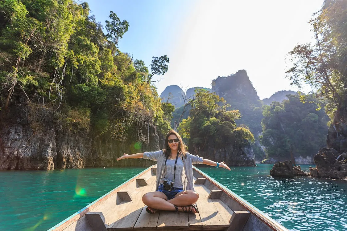 Woman Sitting on Boat Spreading Her Arms spread